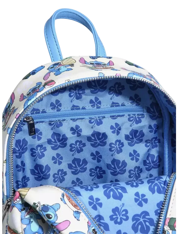 A close-up of a backpack showing its interior and exterior details. The exterior features a white fabric printed with cartoon characters, and the interior is lined with light blue fabric patterned with dark blue hibiscus flowers.