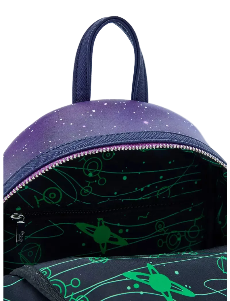 Close-up of a backpack showing the top handle, a purple galaxy-print exterior, a dark interior with a green space-themed pattern, and a silver zipper.