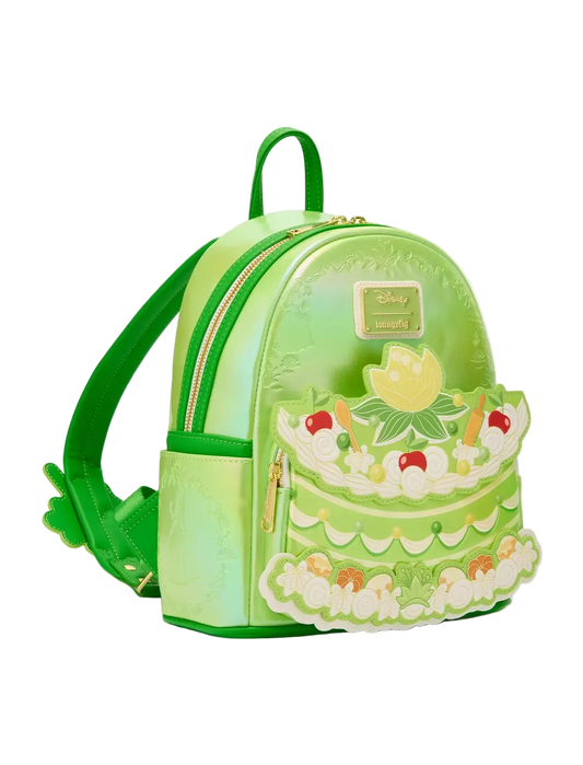 Green cake-shaped backpack with decorative elements on a white background