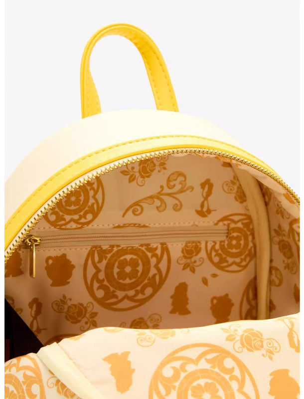 Close-up of a small backpack with a cream exterior, bright yellow trim, and a gold-toned interior pattern featuring Disney characters and floral motifs.