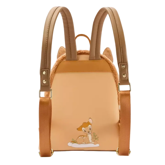A mini backpack styled like a cat-shaped bag, featuring tan faux-leather straps, a peach-colored front panel with an embroidered Bambi character, and faux fur trim, shown on a plain white background.