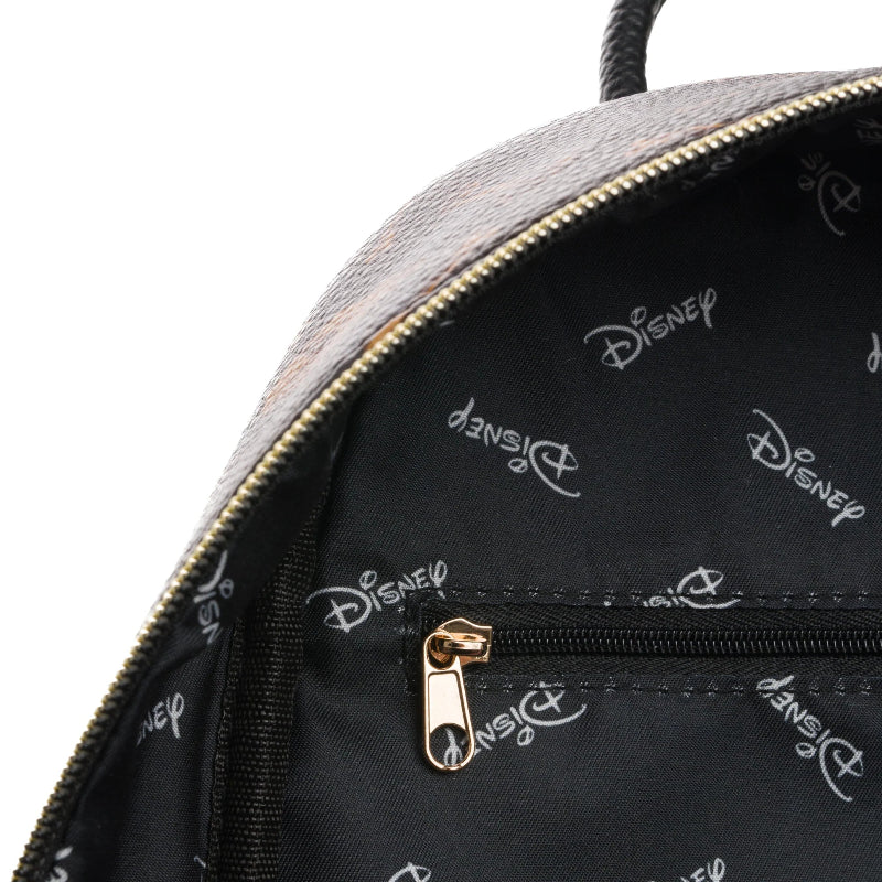 Close-up of a backpack with Disney logo pattern on the black interior.