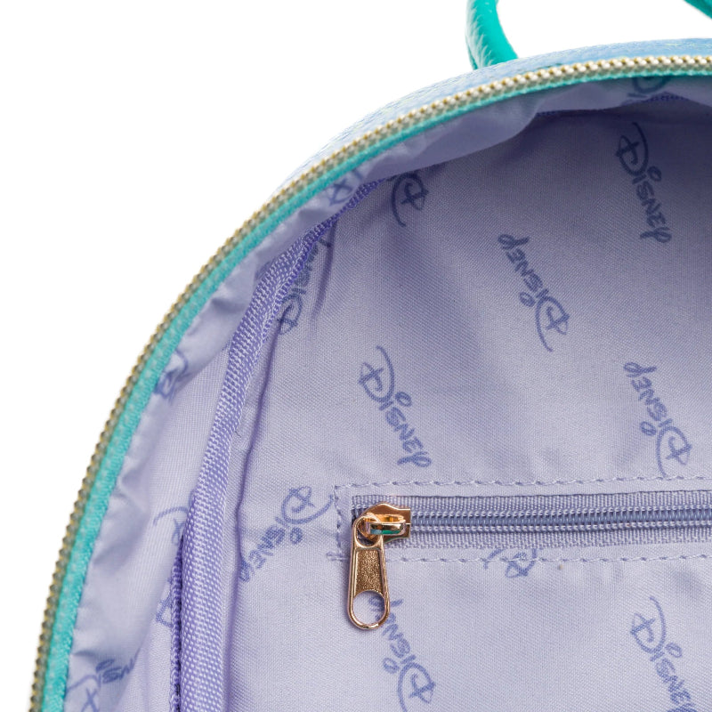 Close-up of a Disney-themed bag with a gold zipper on a light purple background.