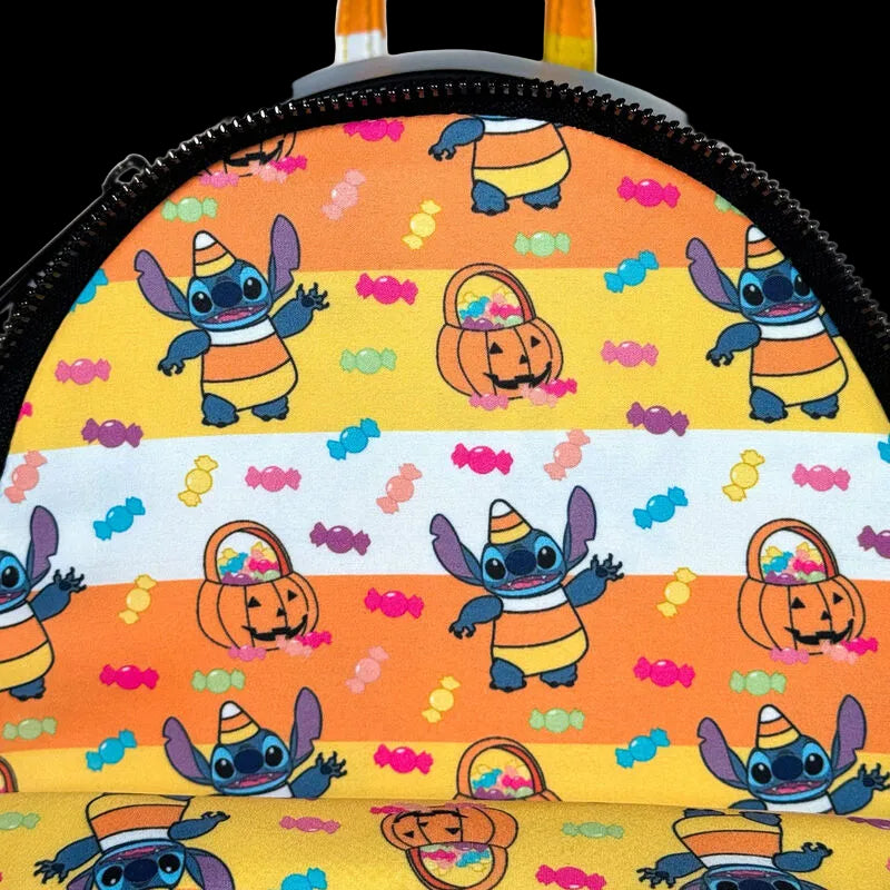 Backpack with Halloween-themed design featuring cartoon character and candy patterns on a striped background.
