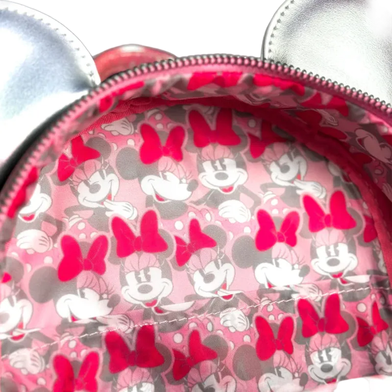 Close-up of a pink patterned bag with cartoon characters and bows.