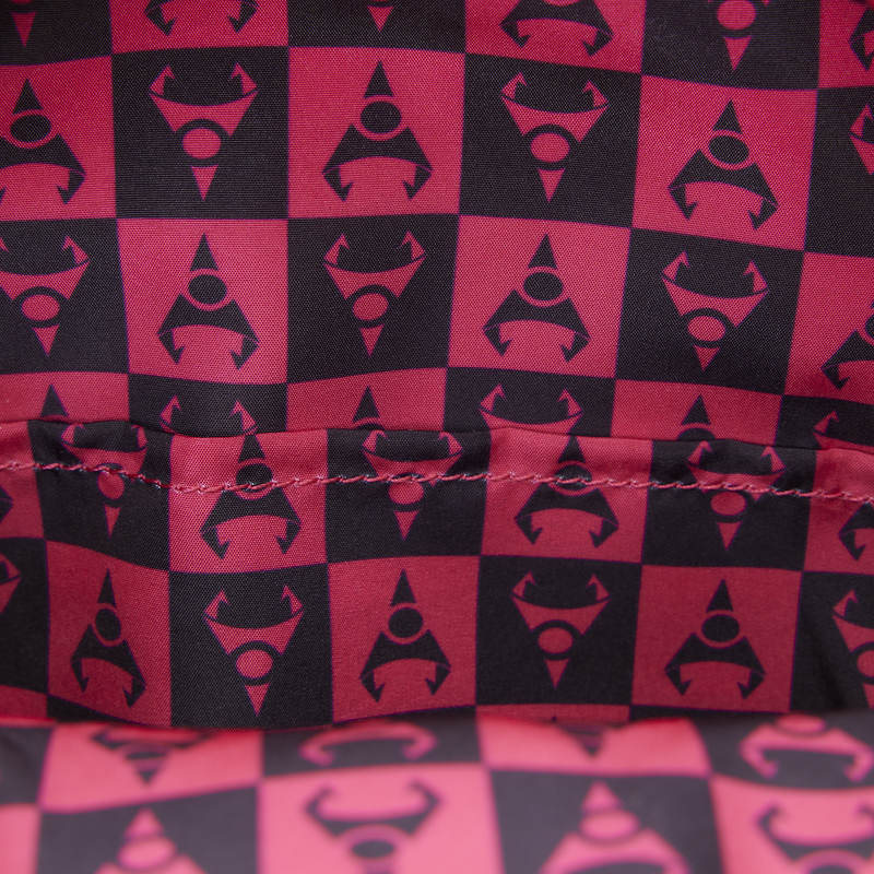 Red and black checkered pattern with a central logo on fabric