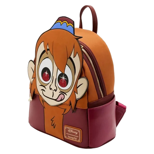 A Disney Aladdin character backpack featuring a large 3D monkey face on the front, with an orange top section, burgundy bottom section, and a blue and yellow hat detail on top.