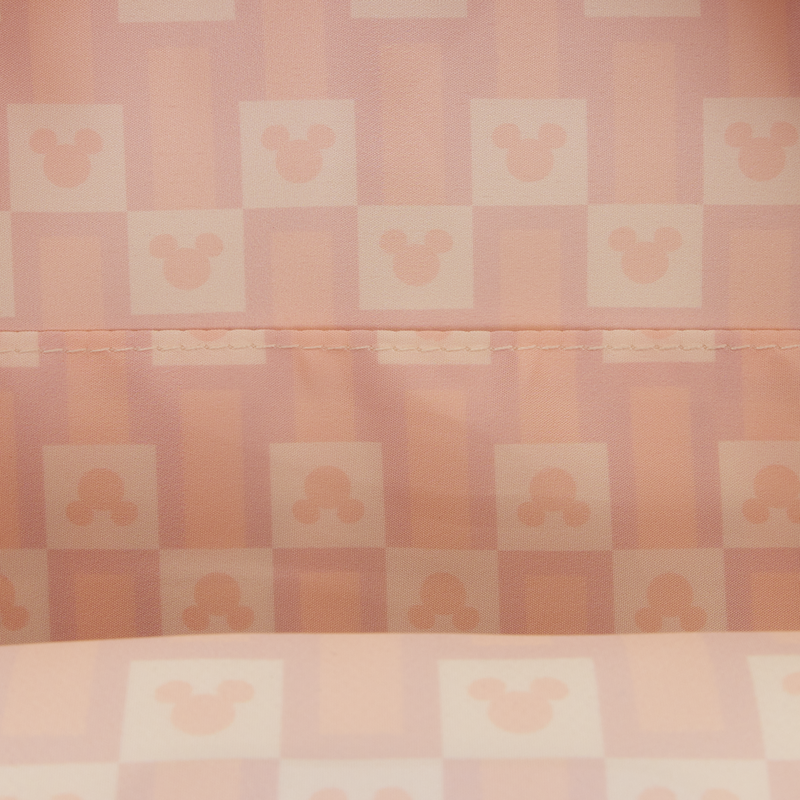 Checkered pattern with a stylized face design on a pink background