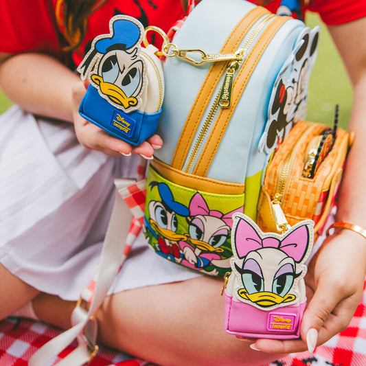 Mickey and Friends mini backpack keychain charm shown on a picnic blanket