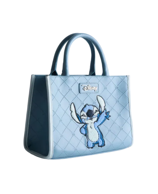Light blue quilted handbag with cartoon character on a light gray background
