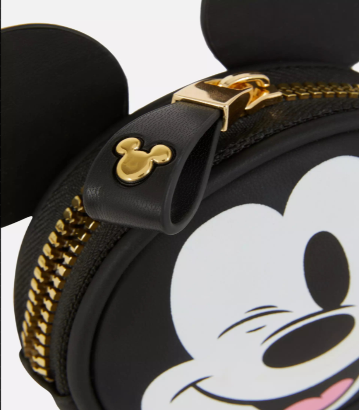 Black round pouch with a cartoon face design and gold zipper pull, featuring a small gold Mickey Mouse head emblem.
