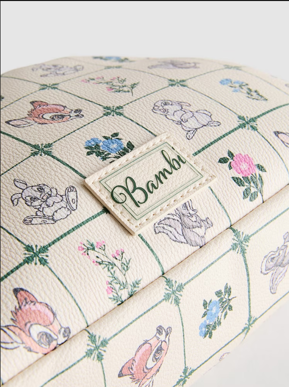 Product with 'Bambi' branding featuring cartoon characters and floral patterns on a checkered background.