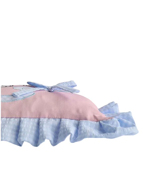 Pink and blue pillow with ruffled edge on a light gray background