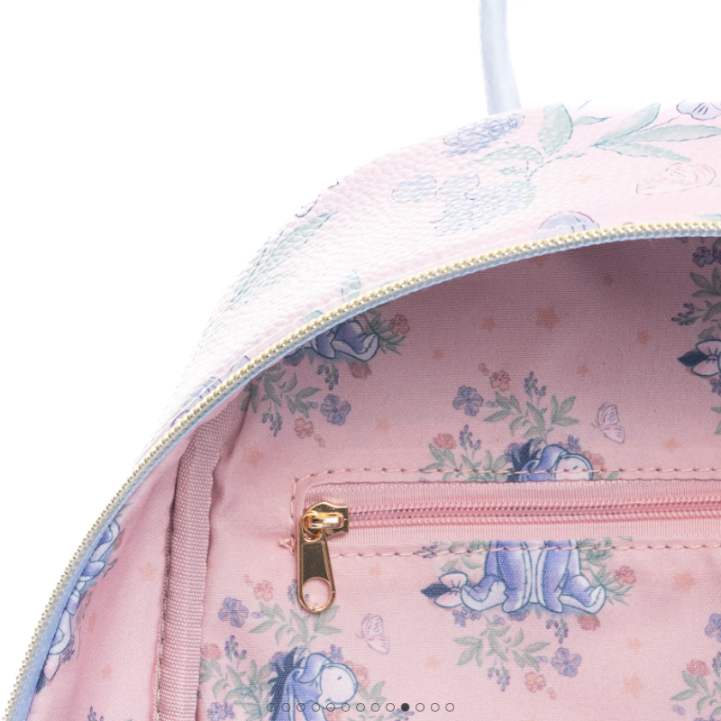 Pink floral-patterned bag with a gold zipper on a white background