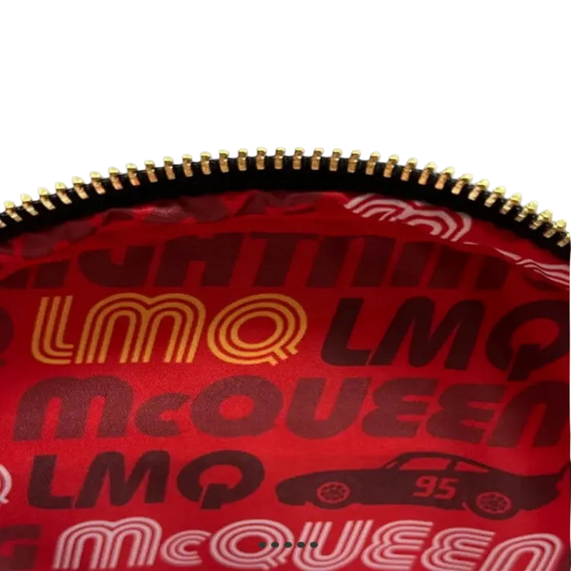 Red bag with gold and black text and graphics, featuring the brand 'LMQ McQueen'.