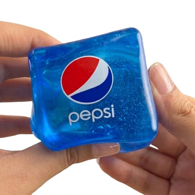 Blue Pepsi ice cube held in a hand against a white background