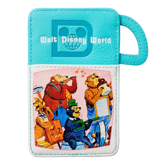 A turquoise and white faux leather luggage tag featuring the Walt Disney World logo and a colorful cartoon illustration of park characters playing instruments on the front pocket.