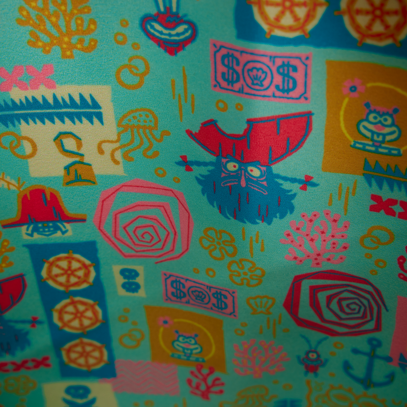 Colorful patterned fabric with various abstract designs on a blue background