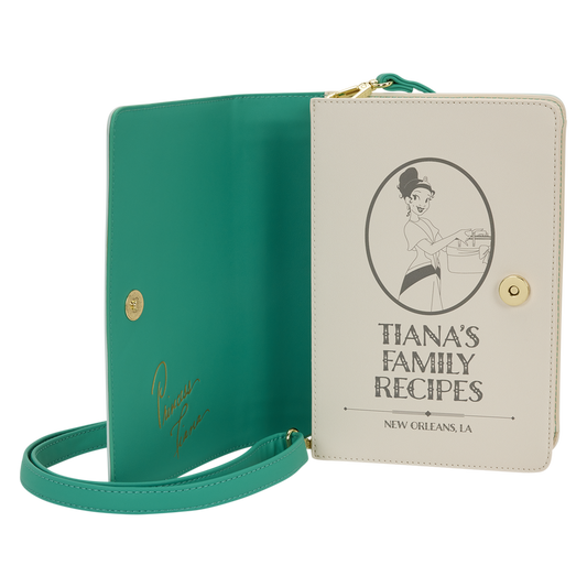 Green book with a strap and beige cover featuring 'Tiana's Family Recipes' on a white background