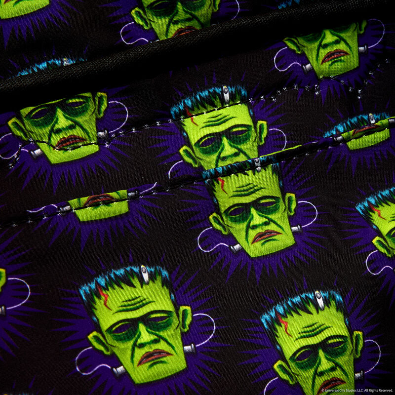 Pattern of green monster faces with purple accents on a black background