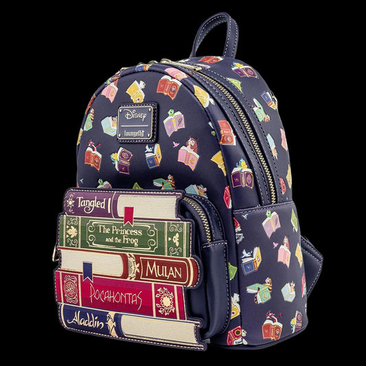 A Disney Loungefly mini backpack featuring a navy blue background with a colorful pattern of books and characters from Aladdin, Cinderella, Tangled, The Princess and the Frog, Mulan, Pocahontas, and Aladdin. The front pocket is styled to look like a stack of book spines, and a silver-tone Disney Loungefly logo patch is visible on the front.