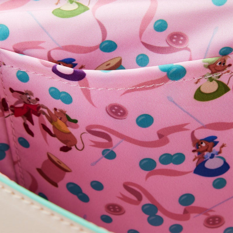 Close-up of a pink fabric with cartoon characters and patterns