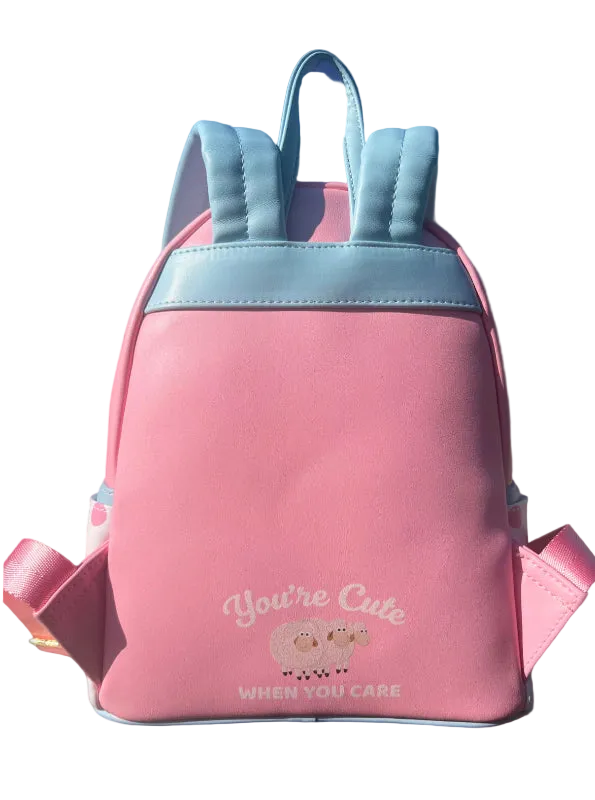 Pink backpack with blue accents on a blue background