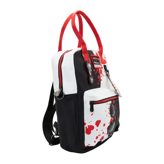 A black and white backpack with red accents, featuring a blood-splatter pattern on the front pocket and red top handles, shown against a plain white background.