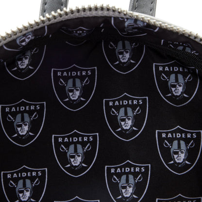 Close-up of a bag with repeated Raiders logo on a black background