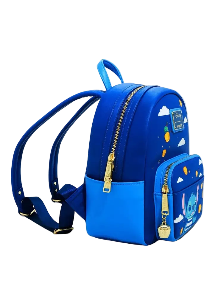 A blue mini backpack with a matching zippered pouch, featuring gold-tone hardware, white cloud prints, and character graphics on a clean white background.