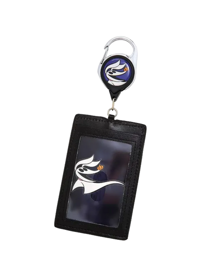 A black leather ID badge holder keychain featuring a retractable badge reel with a purple and white logo, and a clear ID window displaying a matching logo.