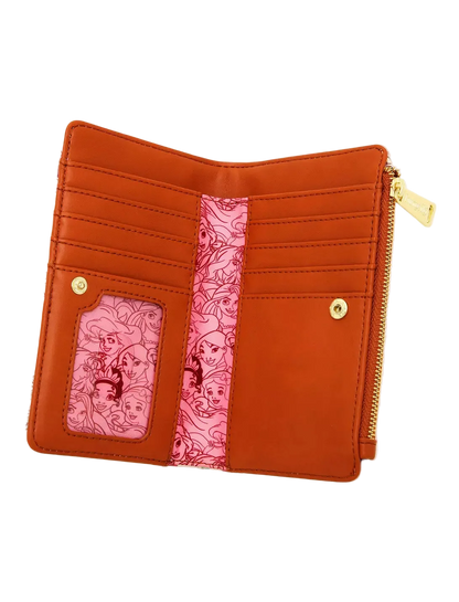 An open orange bifold wallet with gold-tone hardware, featuring a pink patterned center stripe and two pink patterned ID slots on the front, shown on a light gray background.