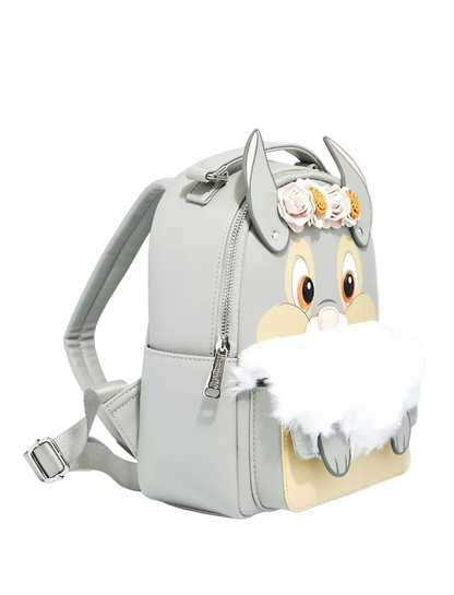 A light gray faux-leather backpack featuring a cartoon rabbit face design on the front, with a fluffy white faux-fur detail, gray ears, and a small floral crown on top.