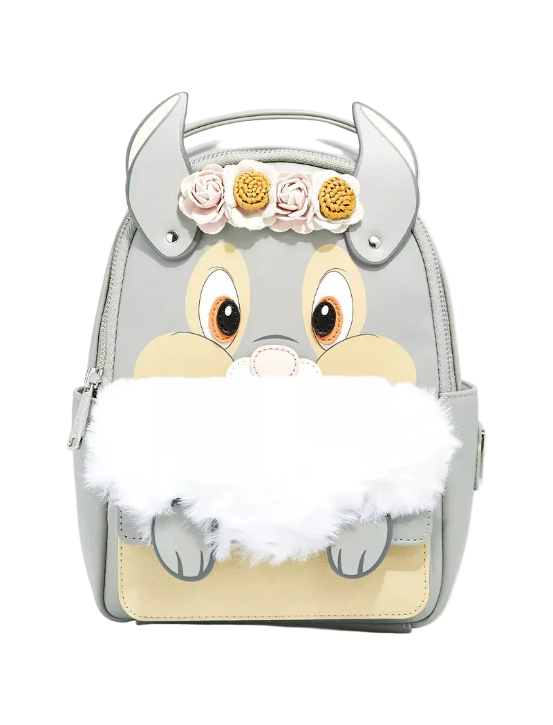 A light gray faux-leather backpack designed like a cartoon animal face with large eyes, a beige snout, gray horns, a white faux-fur beard, and three fabric flowers on the forehead, shown on a light gray background.
