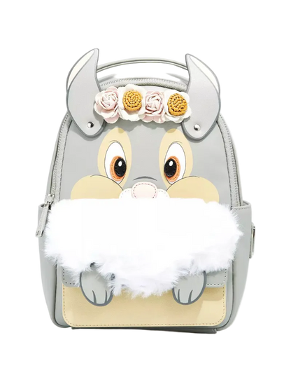 A light gray faux-leather backpack designed like a cartoon animal face with large eyes, a beige snout, gray horns, a white faux-fur beard, and three fabric flowers on the forehead, shown on a light gray background.