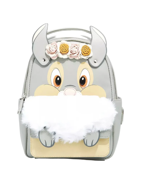A light gray faux-leather backpack designed like a cartoon animal face with large eyes, a beige snout, gray horns, a white faux-fur beard, and three fabric flowers on the forehead, shown on a light gray background.
