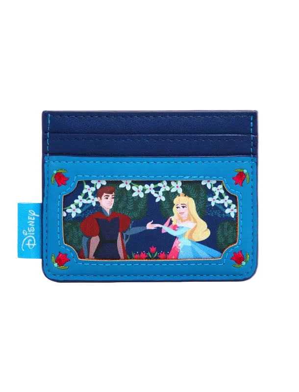 A Disney card holder wallet featuring a blue faux leather design with a central character illustration of Snow White and Princess Aurora under a floral arch, with a blue Disney tag on the left side.