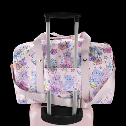 Pink duffel bag with cartoon character and floral pattern on a white background