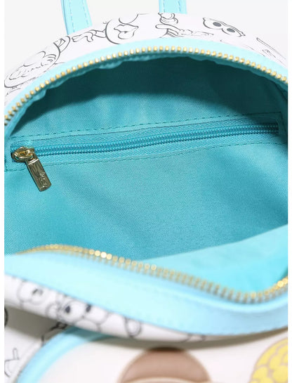 Close-up of the interior of a small backpack or pouch with a light blue lining, a white exterior printed with cartoon faces, and gold-tone zippers.