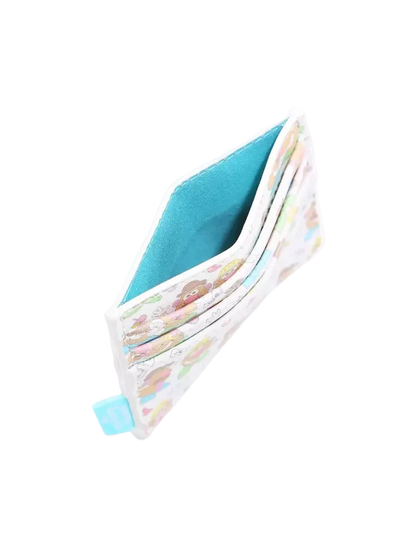 A slim card holder wallet with a white background, pastel multicolor cartoon pattern on the exterior, and a bright turquoise blue interior lining, shown open on a light gray background.