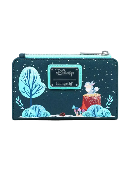 A Loungefly Disney Lilo & Stitch winter-themed zip-around wallet. The dark teal wallet features a printed design of Stitch on a tree stump, a glowing blue tree, and a snowy night sky, with a turquoise nameplate displaying the Disney Loungefly brand.