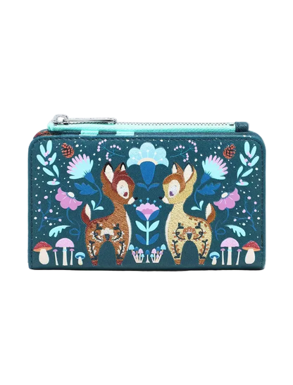 A rectangular zip-around wallet featuring a whimsical forest illustration with two deer, flowers, mushrooms, and a turquoise zipper, shown on a plain light gray background.