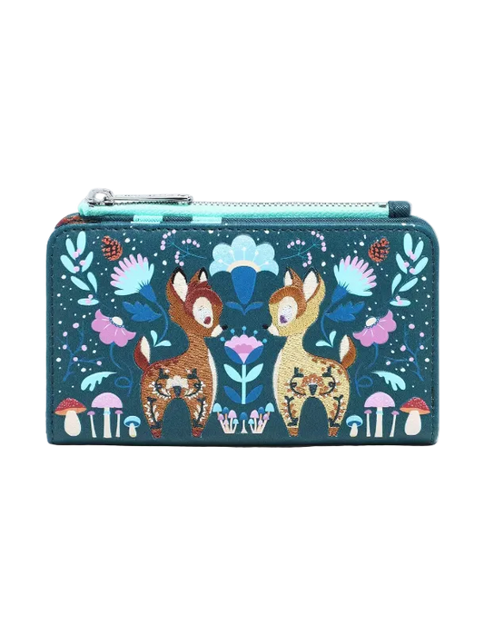 A rectangular zip-around wallet featuring a whimsical forest illustration with two deer, flowers, mushrooms, and a turquoise zipper, shown on a plain light gray background.