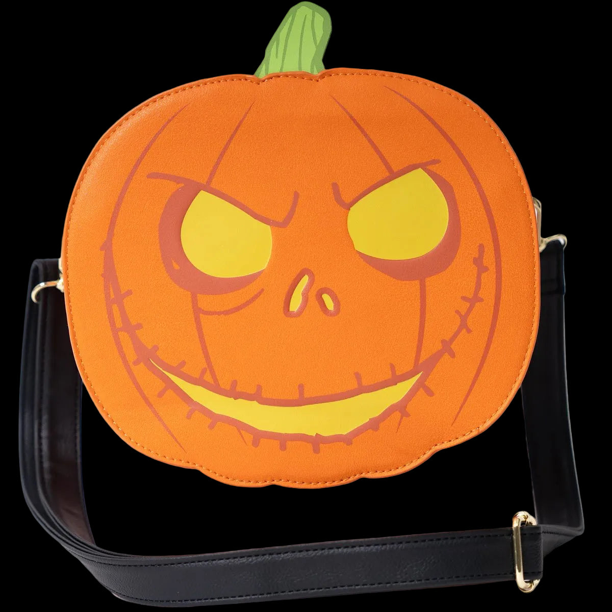 An orange pumpkin-shaped shoulder bag with a carved jack-o'-lantern face, yellow eyes and mouth, a green stem, and a black strap with gold-tone hardware on a white background.