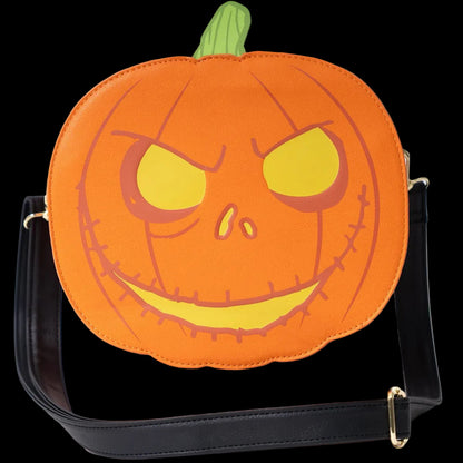 An orange pumpkin-shaped shoulder bag with a carved jack-o'-lantern face, yellow eyes and mouth, a green stem, and a black strap with gold-tone hardware on a white background.