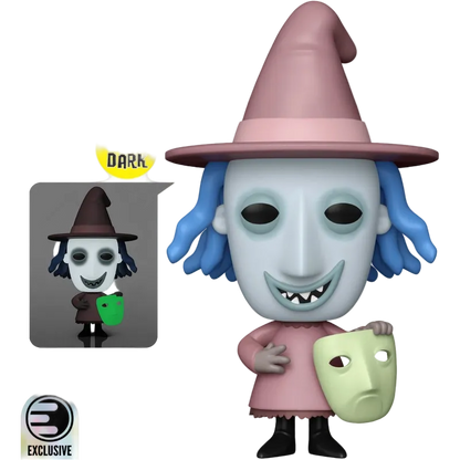 Funko Pop! vinyl figure of Wednesday Addams from The Addams Family, featuring a pale blue-gray mask, pink witch hat and dress, blue hair, and holding a light green mask. Includes a yellow 'Glows in the Dark' badge and an exclusive logo on a white background.