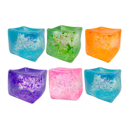 Set of colorful ice cube-shaped candle holders on a white background