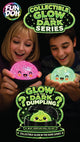 Two children holding glowing dumplings from the Fun Doh Collectible Glow in the Dark Series.