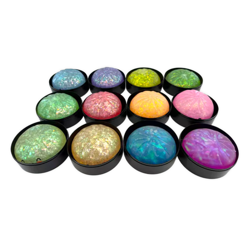 Set of colorful round stones with black bases on a white background