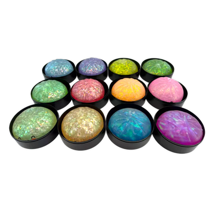 Set of colorful round stones with black bases on a white background